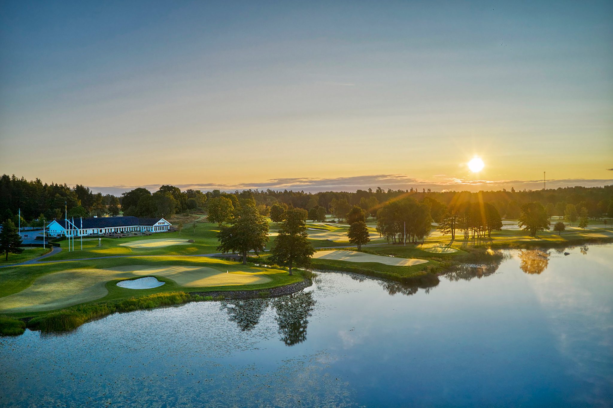 Ullna golf course and clubhouse in evening light.